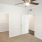 a room with a ceiling fan and white doors