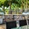 a grill outside with trees in the back