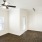 a room with a wood floor and a ceiling fan